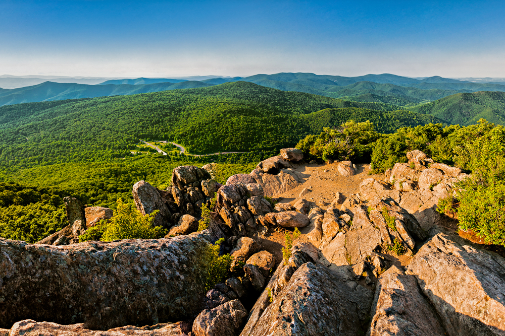 the view from the Mary's Rock Summit Trail. the top of the mountain is full of rocks and you can see the blue and green trees from the national Forrest. this is one of the best hikes in the Shenandoah national park 
