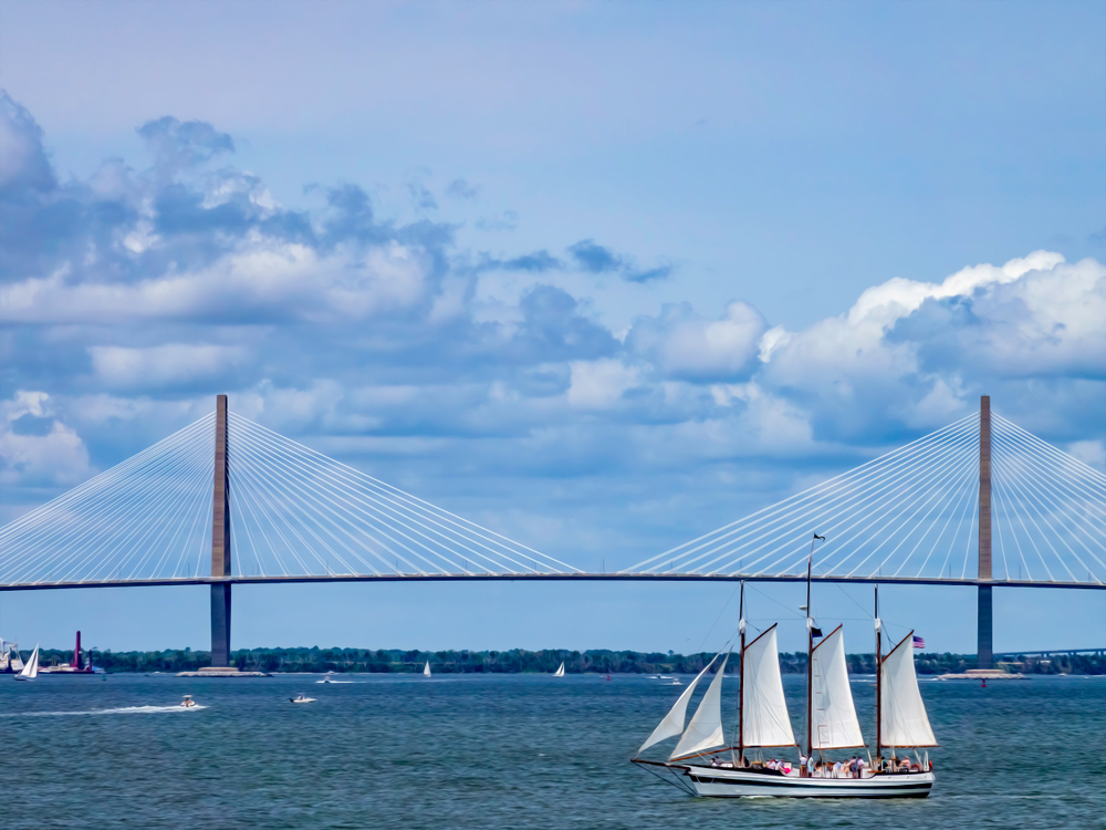 Replica schooner on the water with the Ravenel Bridge in the background.