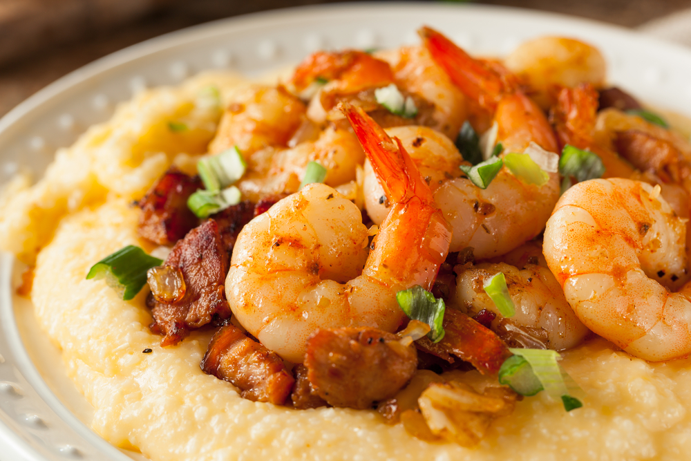 Close up of shrimp and grits with pork and green onions.