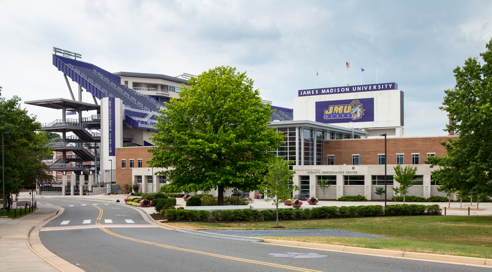 the James Madison university campus with a purple stadium and a clear blue sky 