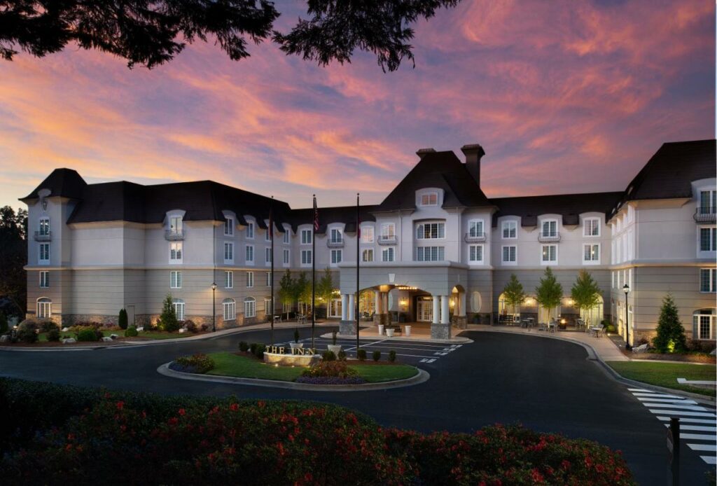 Sunset over the white Chateau Elan Winery and Resort with a grand lawn.