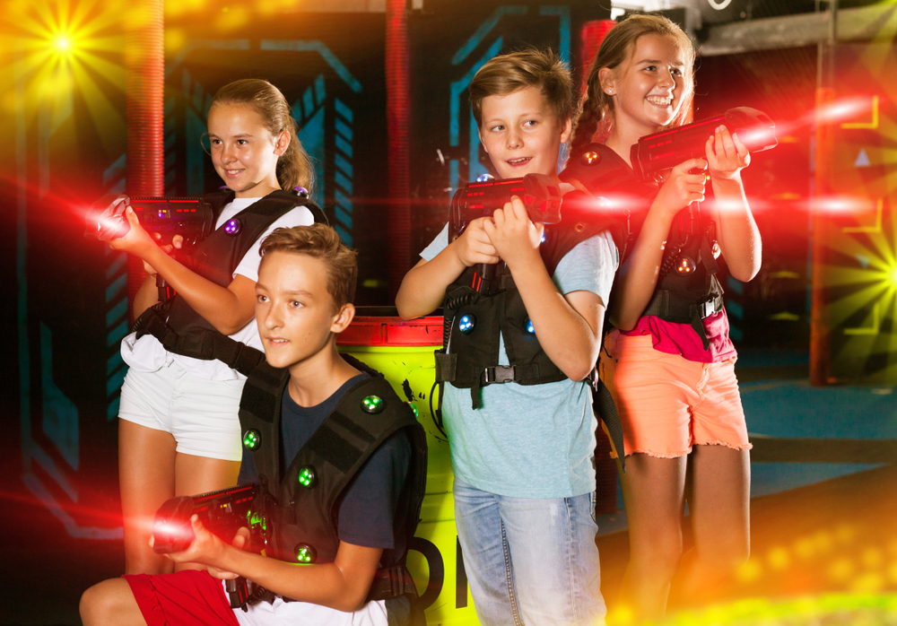 Four kids playing laser tag at Safari Quest. 