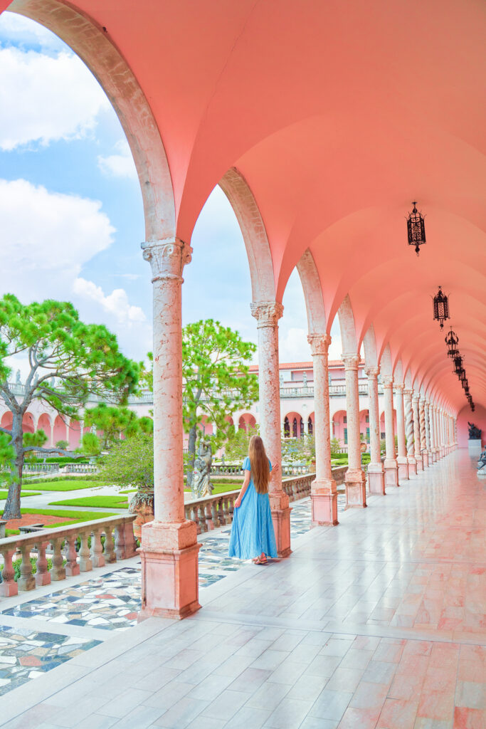 dramatic archway of a museum building with a courtyard garden at the ringling museum in florida