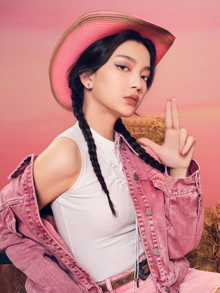 girl in pink jacket and pink cowboy hat. 