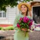 woman standing holding cute bouquet of flowers in a cute nashville outfit