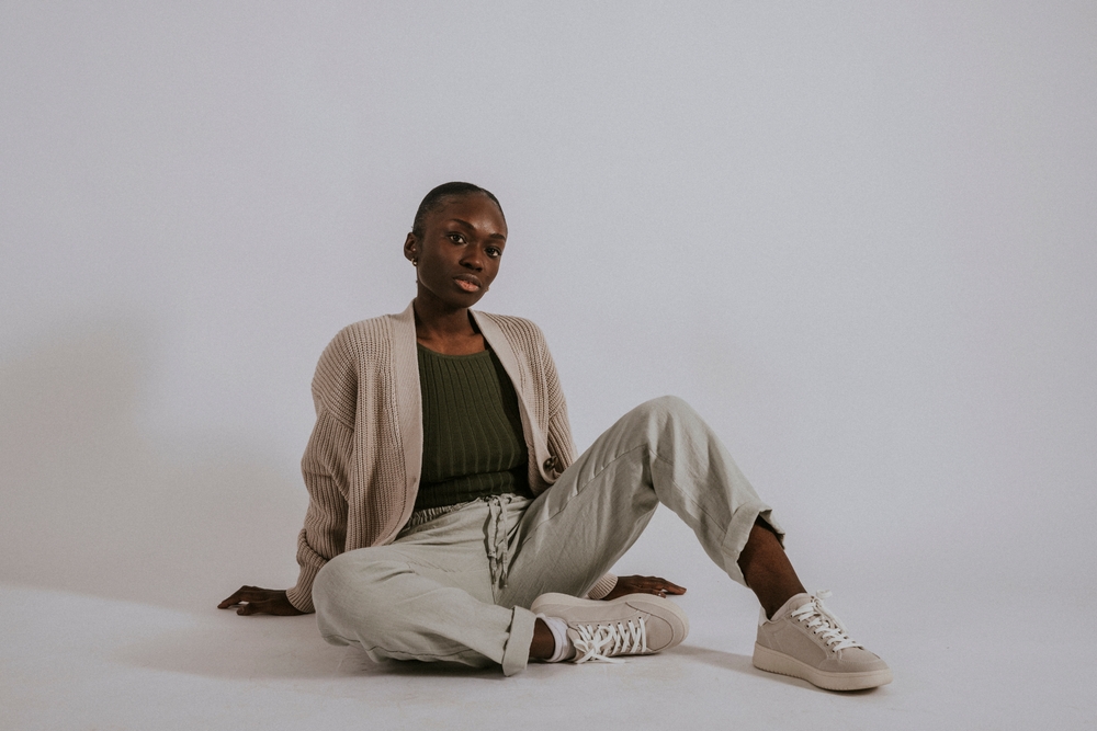 a woman posing in joggers, shirt and cardigan 