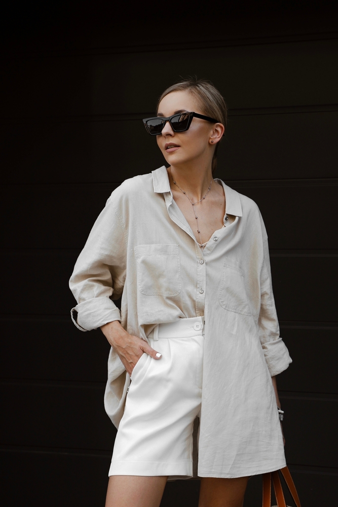 a woman in a matching two piece creme set with long sleeve button up shirt and shorts is perfect if looking at what to wear in washington DC in spring