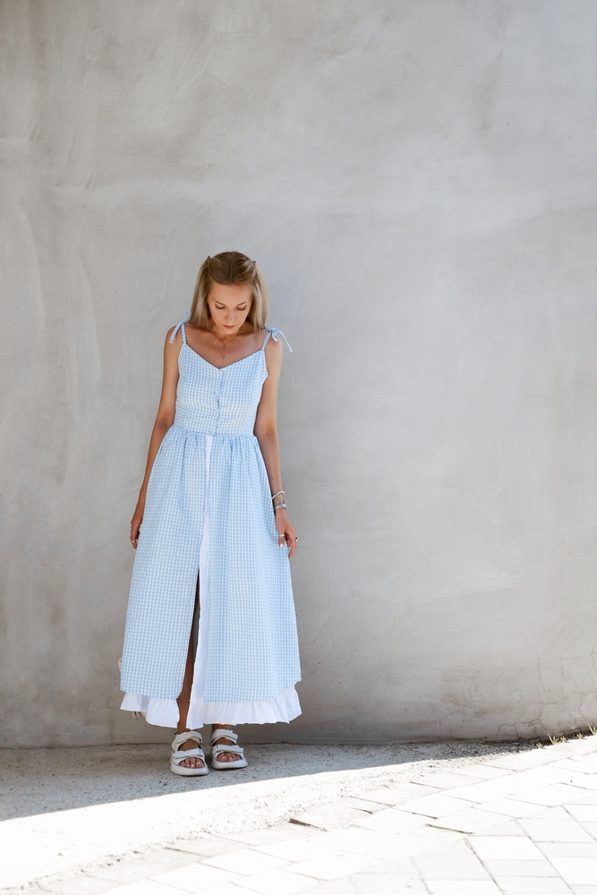 a girl looking down in a long maxi dress with sandals