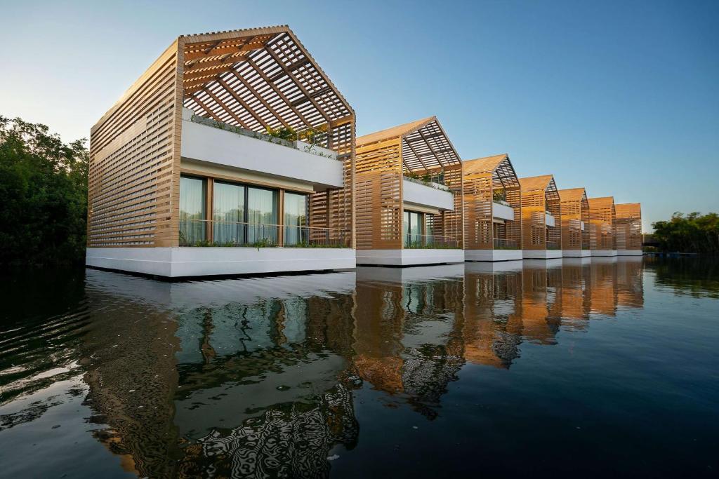 Double height bungalows over the water with a slatted roof. Overwater Bungalows Near The South