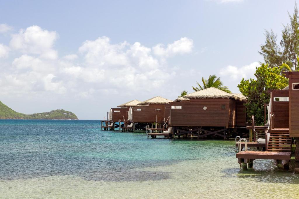 water bungalows against the shore with decks and steps down to the water. Overwater Bungalows Near The South.