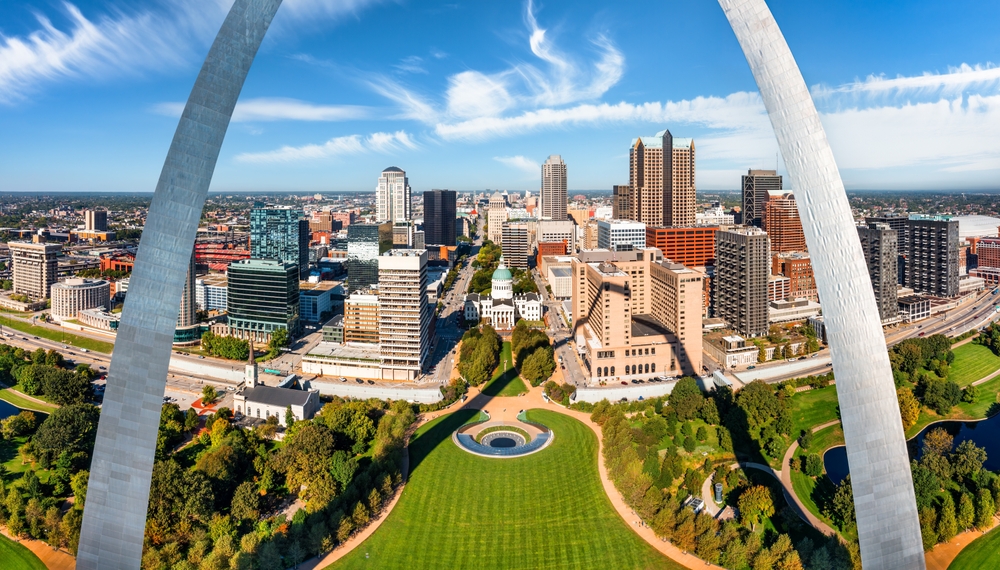 From the view behind the famous St. Louis Arch, home to one of the cheapest places to fly from Atlanta, you can see the greenery of the city and tall buildings! 