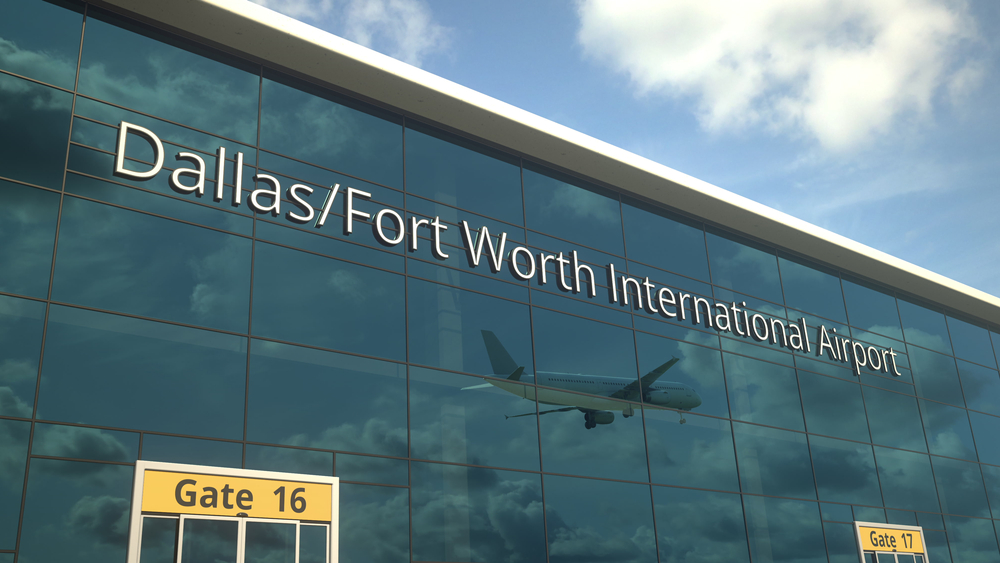 When considering the cheapest places to fly from Dallas, consider which airport to fly from, like the Dallas Fort Worth one, as seen in this photo with its tall glass panels. 