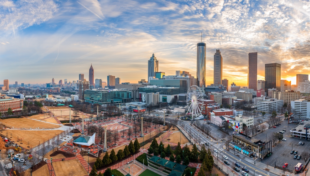 Atlanta, which is one of the cheapest places to fly from Dallas, has a stunning skyline featuring tall buildings at sunset, a ferris wheel, and it is loaded of murals, history and more.