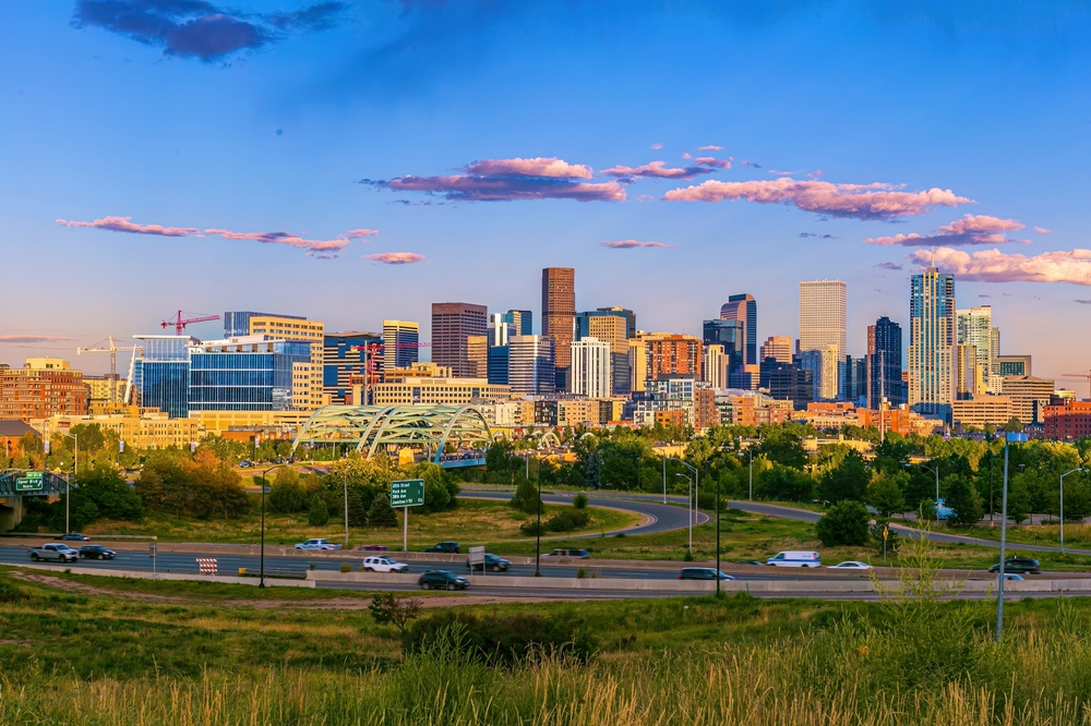Denver, which is one of the cheapest places to fly from Dallas, features stunning greenery, arches, and architecture during golden hour.