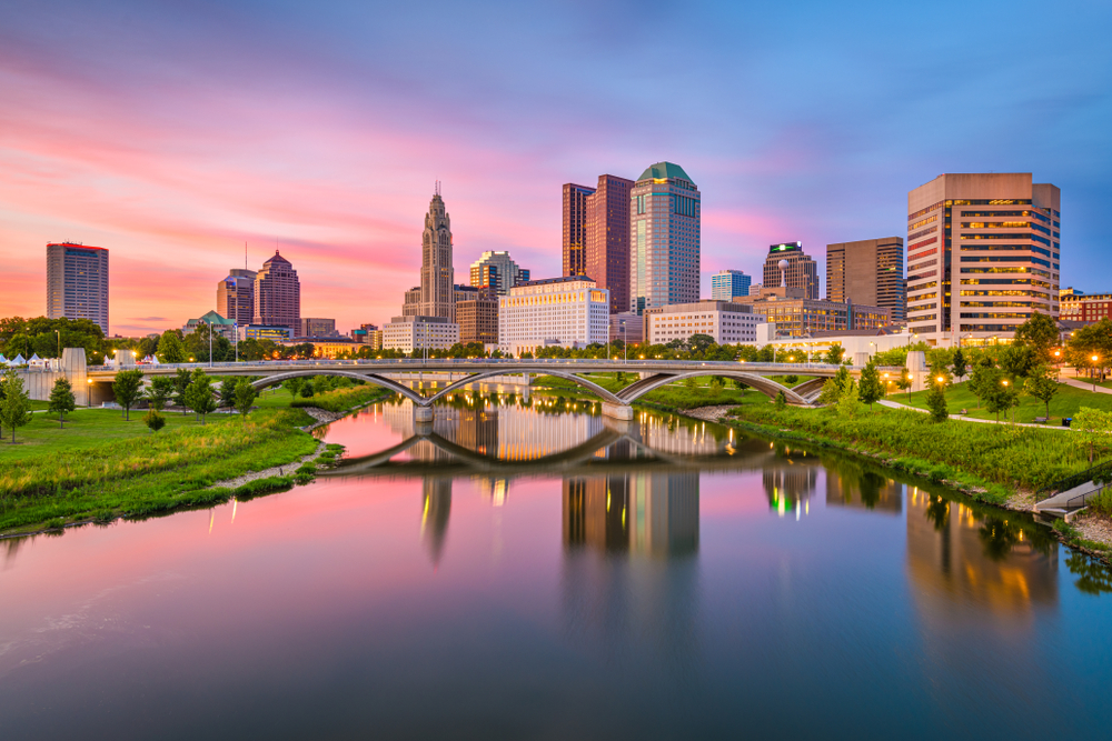 At sunset the skyline of Columbus, which is one of the cheapest places to fly from Washington D.C., reflects the light, showing the urban nature of the city against the forefront of the green parks, and river that cuts through it. 