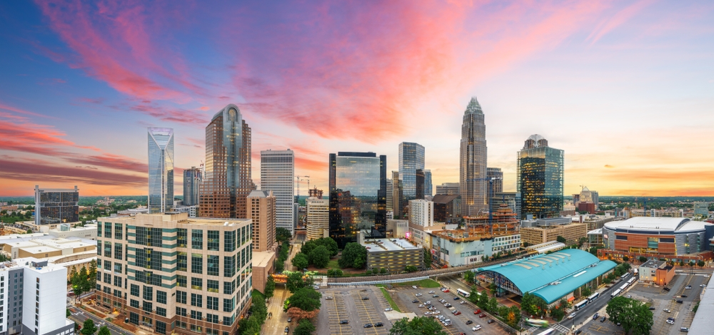 Charlotte's skyline shows an urban city mixed with greens, compact and walkable during the sunset.  