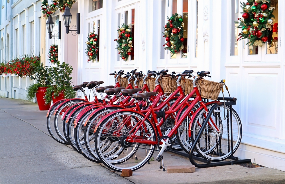 Row of Red Rental Bicycles Parked along Holiday Decorated Street.