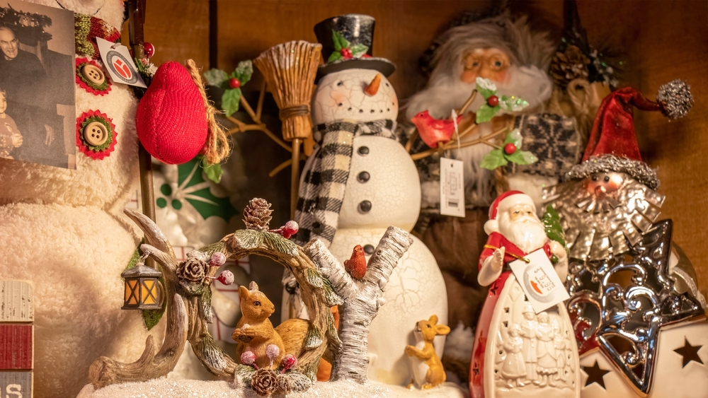 Old-fashioned Christmas decorations with snowmen, santa, and a woodland scene for sale in the Dahlonega General Store, a popular landmark in town. The article is about Christmas in the South USA. 