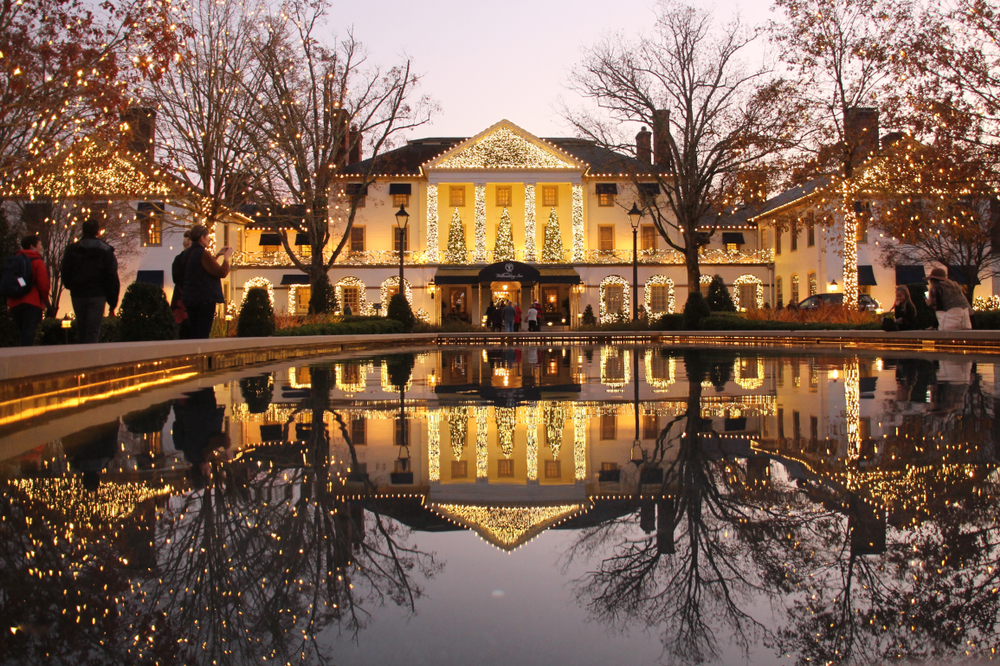 The Williamsburg Inn decorated for the holidays is shown reflected in an outdoor fountain