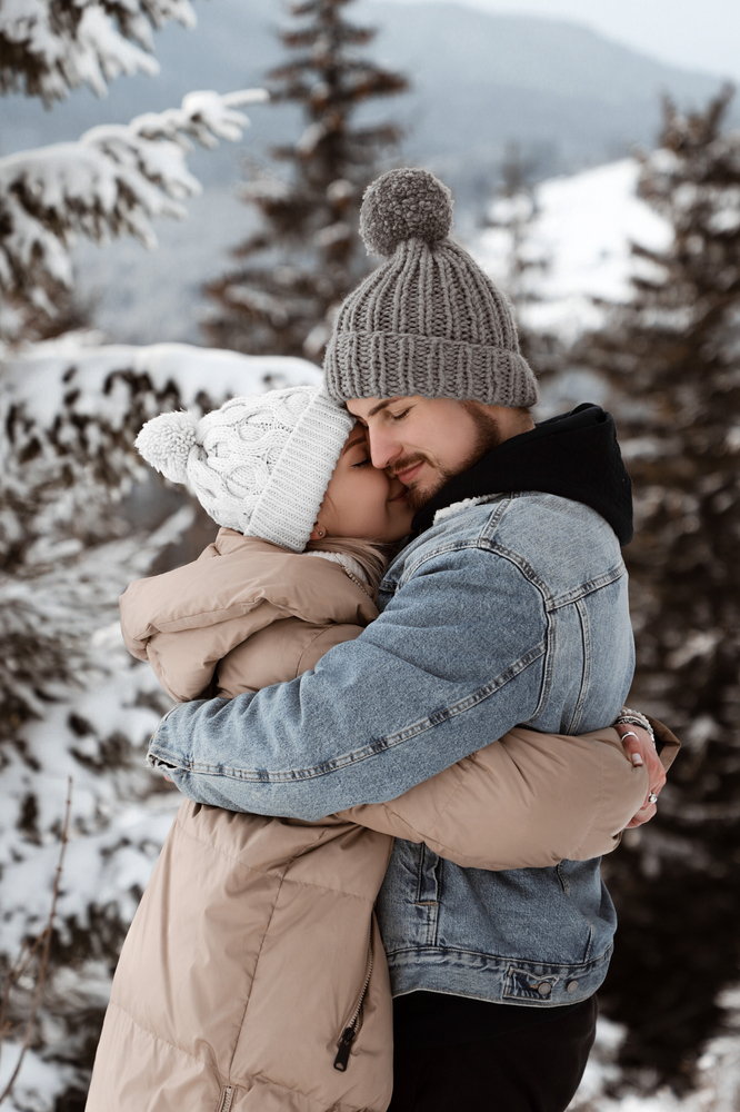 Two people hugging in a snowy scene.