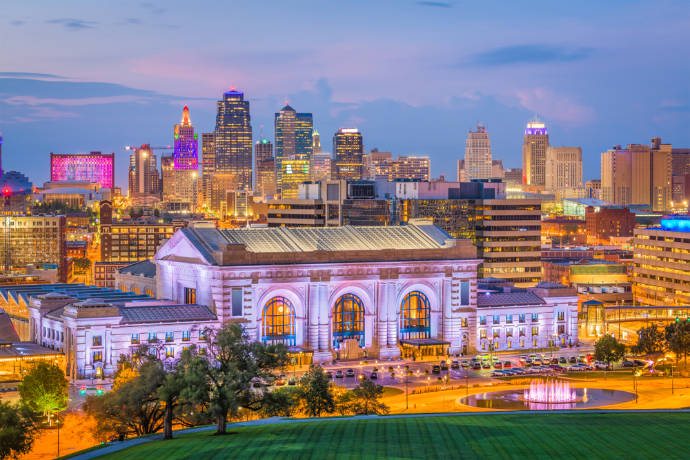 Kansas City, Missouri, USA downtown skyline with Union Station at dusk.